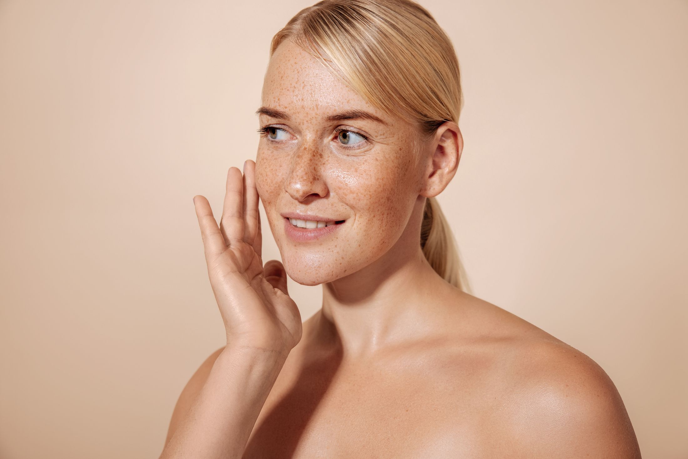 Smiling woman with freckles and natural beauty.